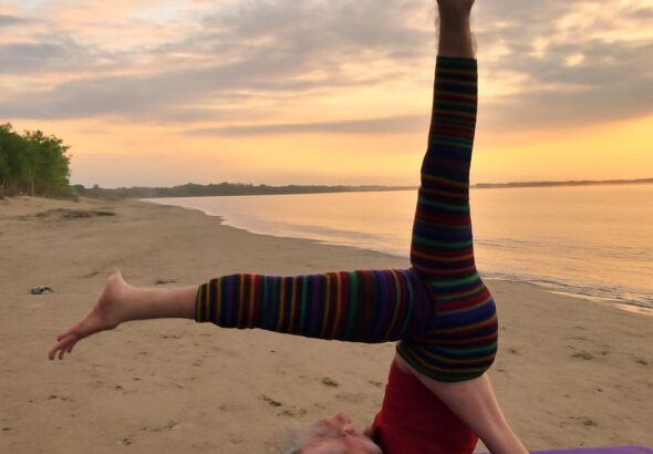 Demonstrating the shoulder stand yoga pose and yoga shoulder stand